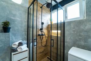 a shower with a glass door in a bathroom at Diocles Place in Split +27 photos