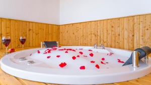 a bath tub with hearts on it with two glasses of wine at Erel Apart in Kas +23 photos