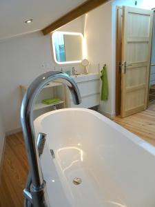 a bathroom with a white sink and a mirror at Agréable maison au centre historique de Foix avec garage in Foix +8 photos