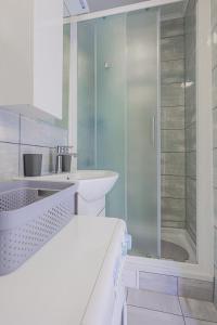 a bathroom with a glass shower and a sink at Apartman Marica in Split