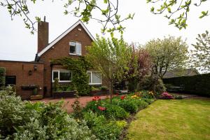 a house with a garden in front of it at Morwick House B&B in Warkworth