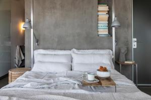 a bedroom with a white bed with a tray on it at Seaview Villa Schinias in Schinias