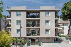 an apartment building with a white facade at Club Hotel in Gabicce Mare