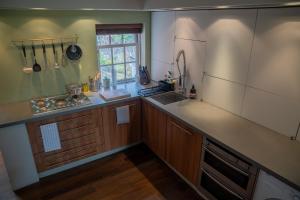 a kitchen with a sink and a counter top at No 33 Stylish and Modern 1 Bed Apartment in Cheltenham