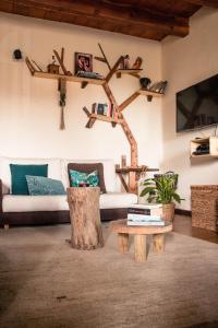 sala de estar con sofá y mesa de centro con troncos de árbol en Social Garden, en Calci