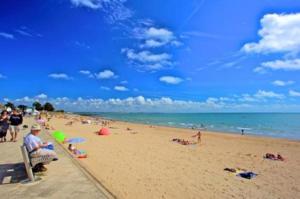 a group of people on a beach with the ocean at Maison de Caractère Maryann56 in Noyal-Muzillac +2 photos