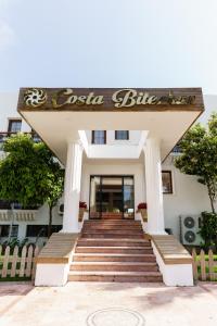 a entrance to a building with stairs and a sign at Costa Bitezhan Hotel - All Inclusive in Bitez