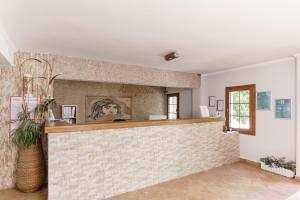 a bar in a room with a brick wall at Costa Bitezhan Hotel - All Inclusive in Bitez