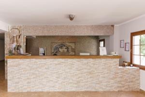 a bar in a room with a brick wall at Costa Bitezhan Hotel - All Inclusive in Bitez