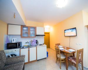 a small kitchen with a table and a dining room at ALEKS Top Center in Burgas