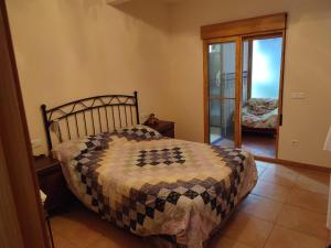 a bedroom with a bed with a quilt on it at Apartamentos Casa May II - Centro Benidorm in Benidorm