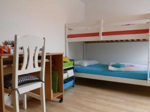 a bedroom with two bunk beds and a desk at Ferienwohnung "Zur Schmiede" Objekt-ID 11824 in Torgelow am See