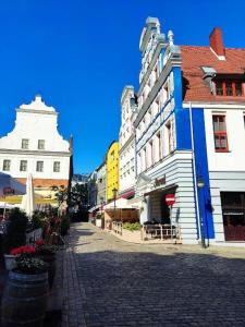 a cobblestone street in a city with buildings at Apartament Smart in Szczecin