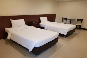 A bed or beds in a room at V Resotel