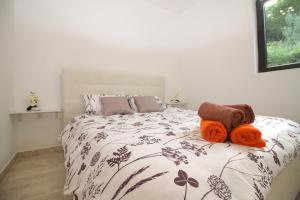 a bedroom with a bed with orange towels on it at Apartaments Paradise in Koper