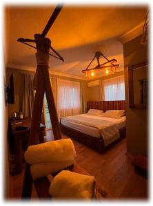 a bedroom with a bed with a fan on the ceiling at Senler Boutique Hotel in Sapanca