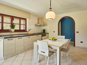a kitchen with a white table and chairs at Apartment Serena - LMZ180 by Interhome in Riva