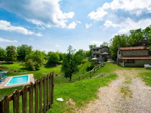 an image of a yard with a fence and a house at Holiday Home Paradiso I by Interhome in Bolognana