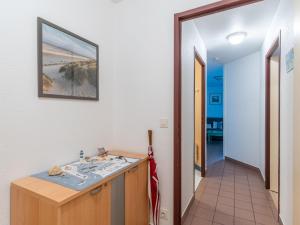 a hallway with a bathroom with a sink at Apartment Village Cheval Spa Résidences-4 by Interhome in Lacanau-Océan