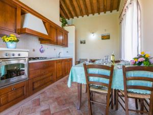 a kitchen with a table with chairs and a stove at Holiday Home Il Corbezzolo-1 by Interhome in San Vincenzo +41 photos