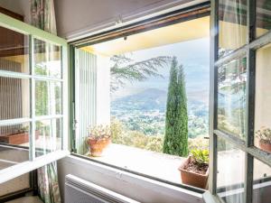 a window with a view of a mountain at Holiday Home Les Ondes by Interhome in Saint-Jean-du-Gard