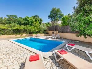 a swimming pool with two lounge chairs and a swimming pool at Holiday Home Mas Pere by Interhome in Calonge