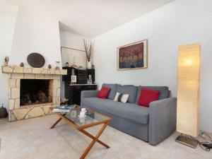 a living room with a couch and a fireplace at Holiday Home Mas Pere by Interhome in Calonge +14 photos