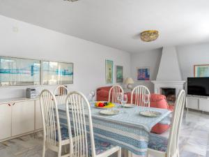 a kitchen and dining room with a table and chairs at Villa Querida by Interhome in Mijas Costa +24 photos