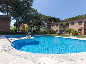 a swimming pool in front of a building at Holiday Home Club by Interhome in Calonge