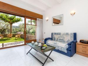 a living room with a blue couch and a table at Holiday Home Club by Interhome in Calonge