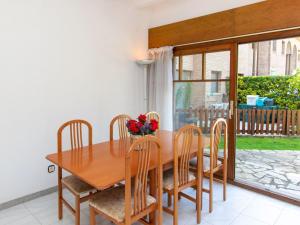 a dining room with a wooden table and chairs at Holiday Home Club by Interhome in Calonge