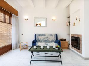 a living room with a table and a couch at Holiday Home Club by Interhome in Calonge +13 photos