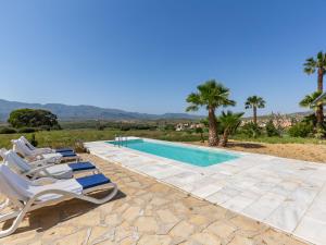 a villa with a swimming pool and lounge chairs at Holiday Home Finca La Veleta by Interhome in Los Gallardos