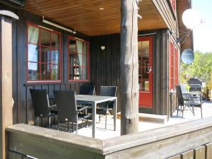 a patio with a table and chairs on a building at Chalet Koven - SOW114 by Interhome in Øyuvstad
