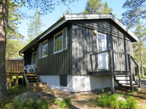 a tiny house in the woods with a porch at Chalet Trygvebu by Interhome in Øyuvstad