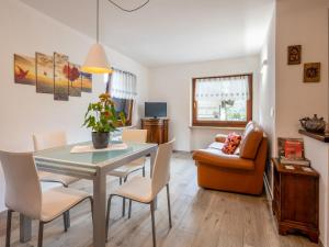 a dining room and living room with a table and chairs at Apartment Cima by Interhome in Aosta