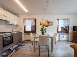 a kitchen and dining room with a table and chairs at Apartment Cima by Interhome in Aosta