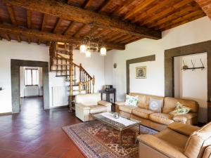 a living room with a couch and a table at Holiday Home La Casina by Interhome in Pieve a Maiano +18 photos