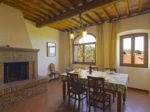 a dining room with a table and a fireplace at Holiday Home La Casina by Interhome in Pieve a Maiano