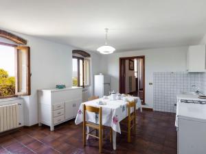 a kitchen with a table and chairs in a room at Holiday Home La Casina by Interhome in Pieve a Maiano
