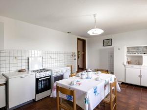 a kitchen with a table and a stove top oven at Holiday Home La Casina by Interhome in Pieve a Maiano