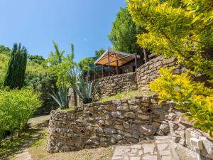 a stone wall with a house on top of it at Holiday Home Vittorio by Interhome in Montorgiali