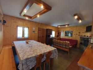 a dining room with a table and a couch at Holiday Home Irma by Interhome in Porlezza