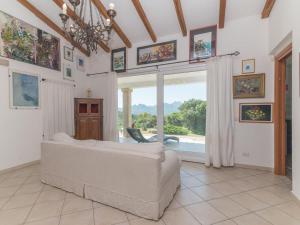 a bedroom with a bed and a large window at Holiday Home Nanai by Interhome in Cannigione