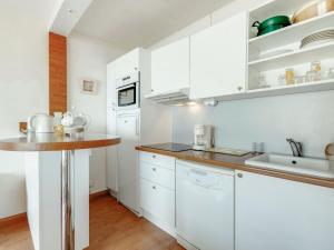 a kitchen with white cabinets and a counter top at Apartment Prince Albert by Interhome in Cabourg