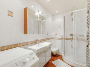 a white bathroom with a sink and a shower at Apartment Prince Albert by Interhome in Cabourg