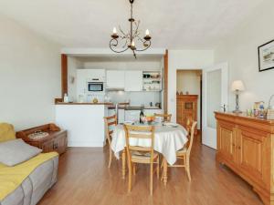 a kitchen and dining room with a table and chairs at Apartment Prince Albert by Interhome in Cabourg