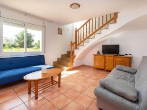 a living room with a couch and a tv at Villa Villa Mimosa I by Interhome in Les tres Cales +14 photos