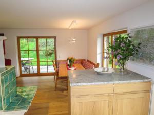 a kitchen with a counter and a dining room at Holiday Home Schwänli by Interhome in Oberammergau