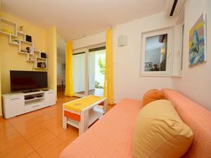 a living room with a couch and a television at Holiday Home Željko by Interhome in Zaglavice +16 photos